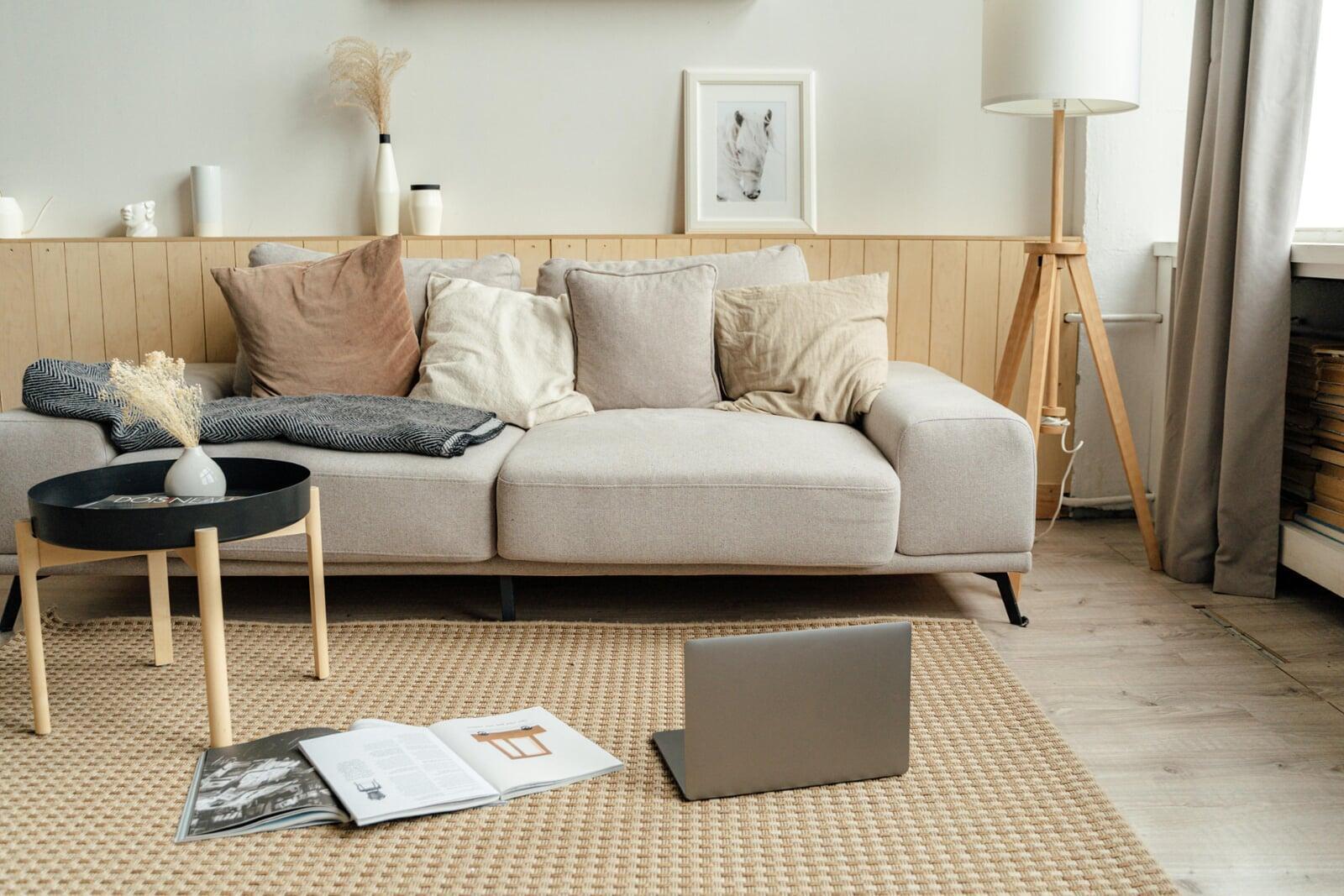 Cozy couch and laptop and papers on the floor